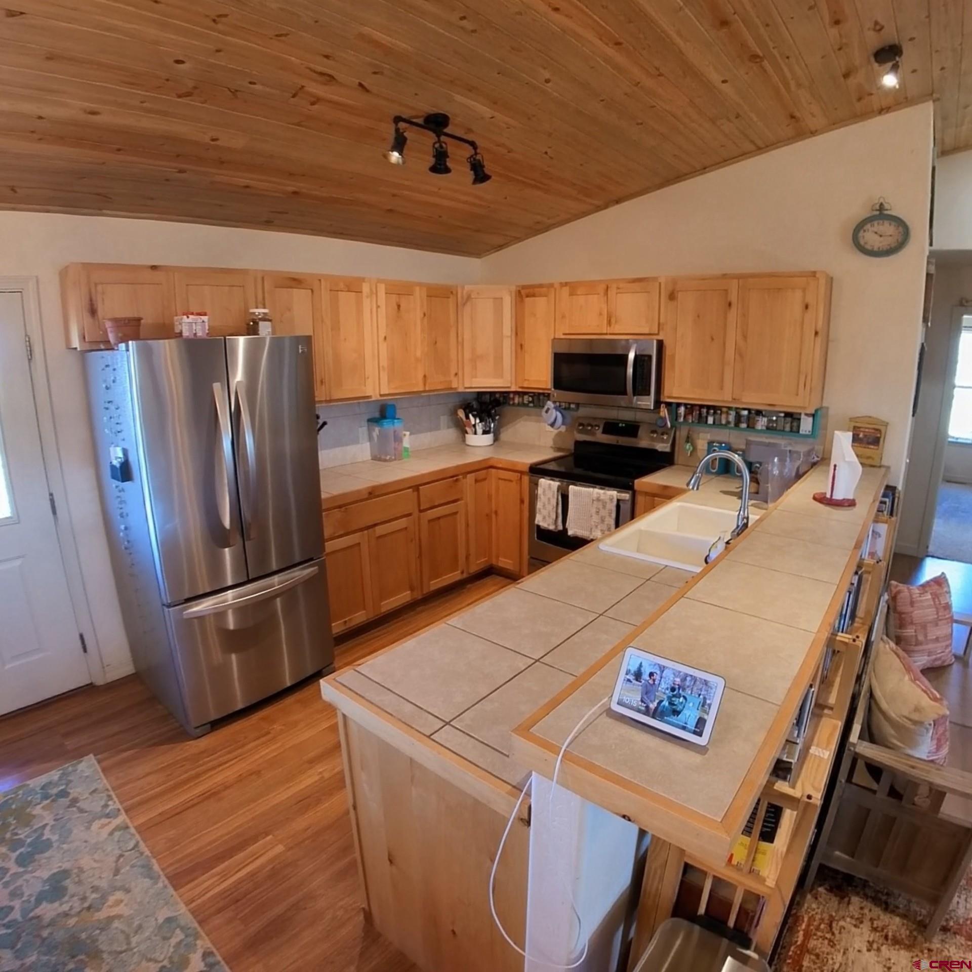 14617 2800th Road Hotchkiss, CO 81419 - Photo 19 of 37 a kitchen with stainless steel appliances granite countertop a refrigerator and a stove top oven