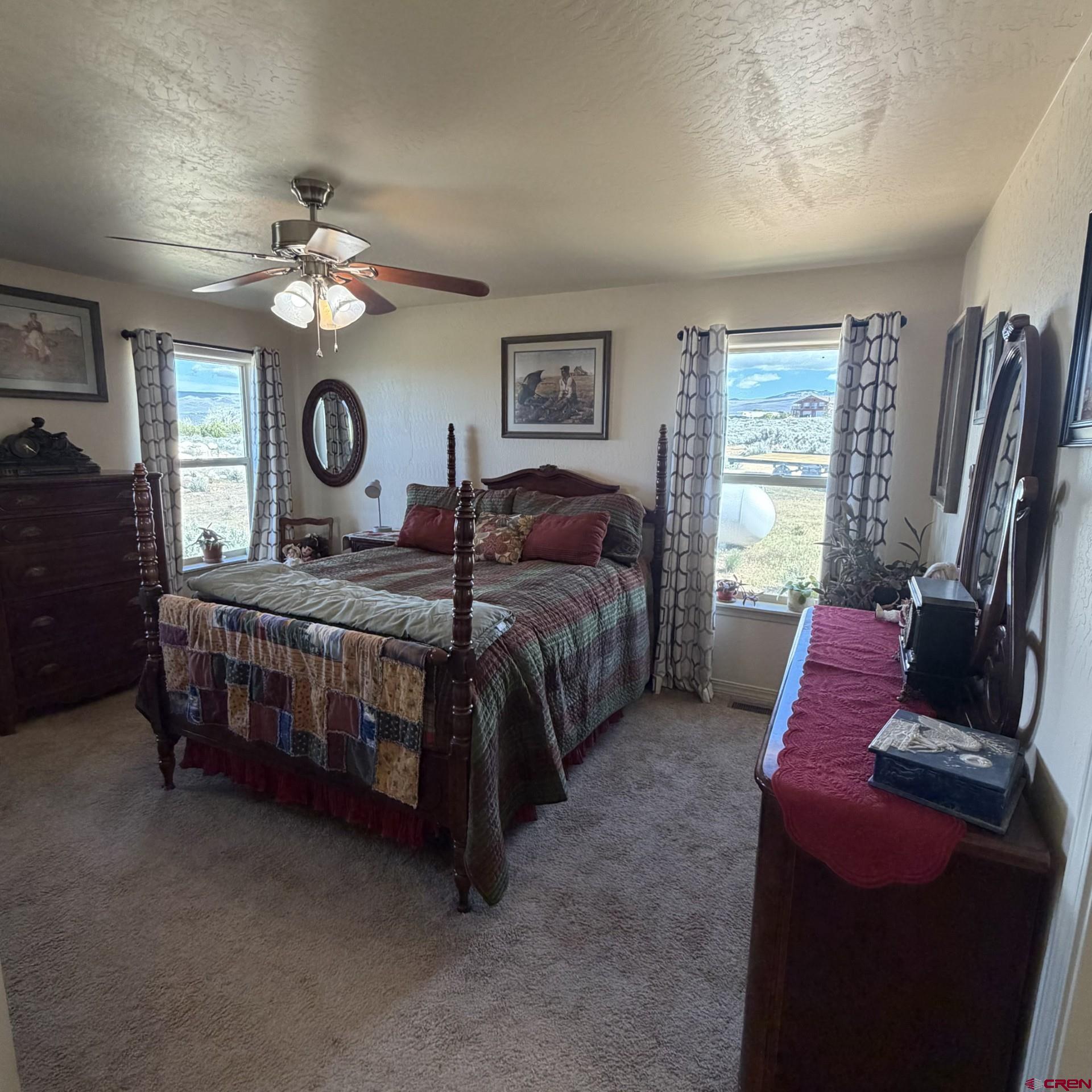 14617 2800th Road Hotchkiss, CO 81419 - Photo 22 of 37 a bedroom with a bed a window and a flat screen tv