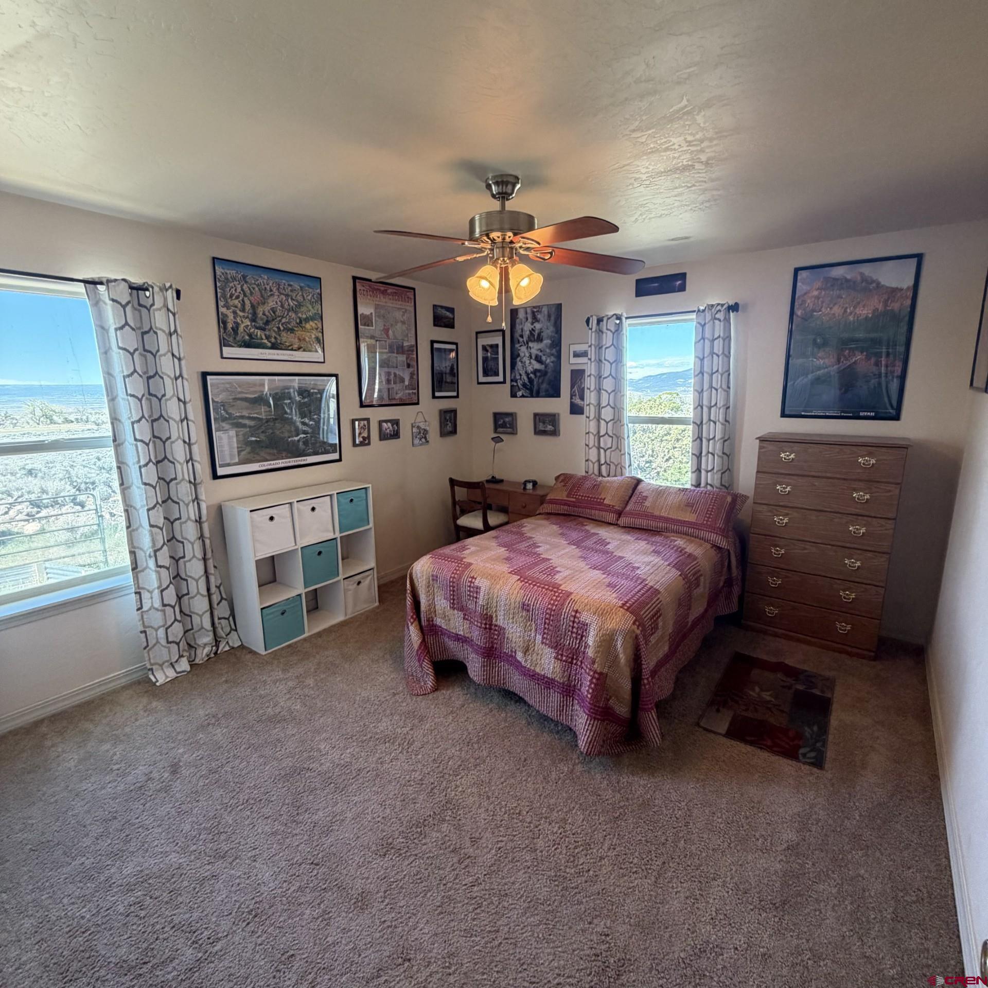 14617 2800th Road Hotchkiss, CO 81419 - Photo 26 of 37 a spacious bedroom with a bed dresser and a window