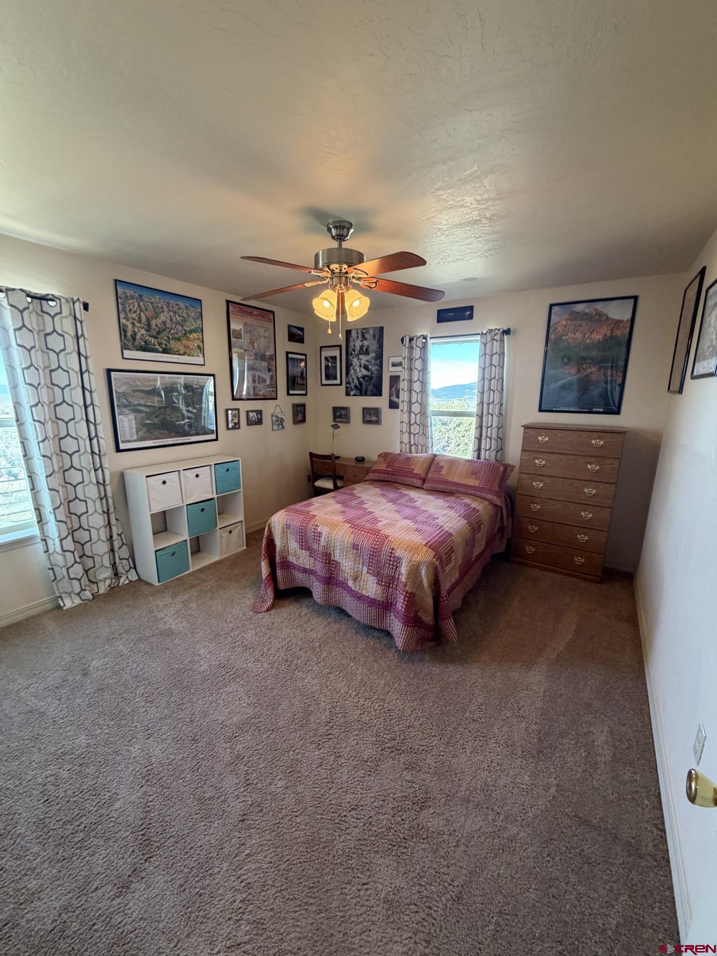 14617 2800th Road Hotchkiss, CO 81419 - Photo 27 of 37 a bedroom with a bed and a chandelier