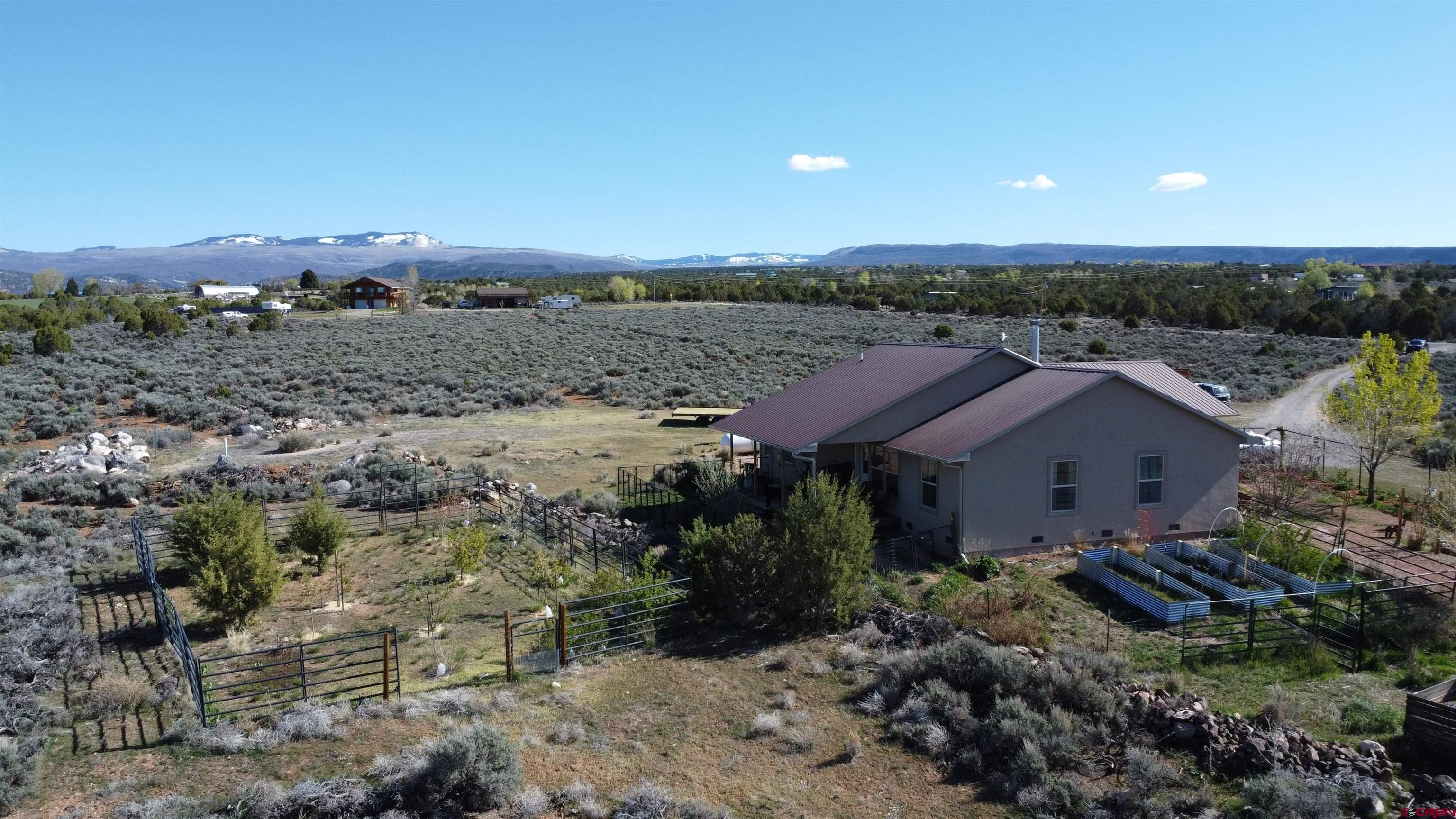 14617 2800th Road Hotchkiss, CO 81419 - Photo 5 of 37 an aerial view of a house with a yard