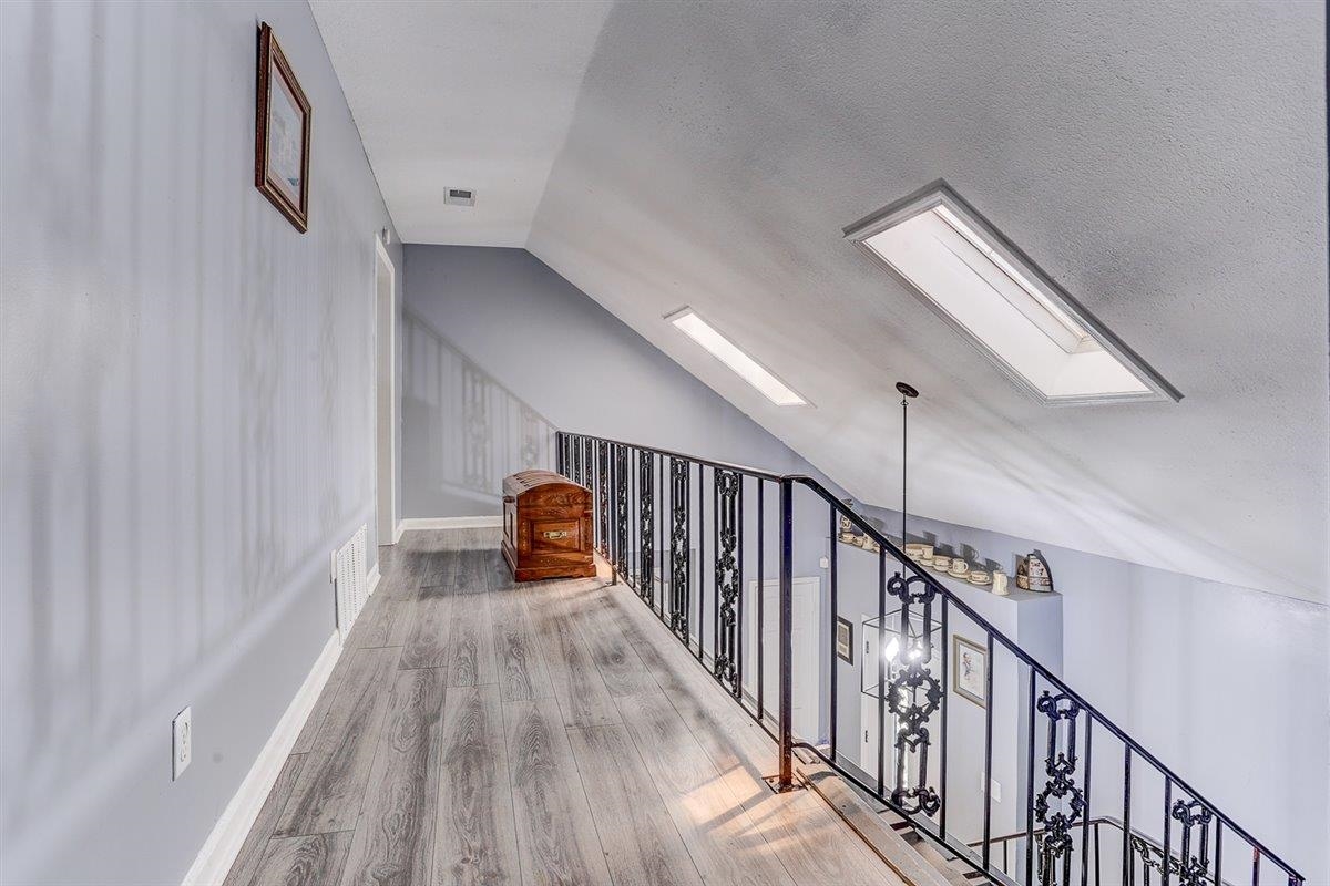 3700 Lakeview Road Memphis, TN 38116 - Photo 30 of 40 Additional living space featuring lofted ceiling, wood finished floors, a skylight, and a textured ceiling