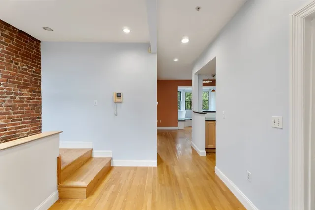 a view of a room with wooden floor and a bathroom