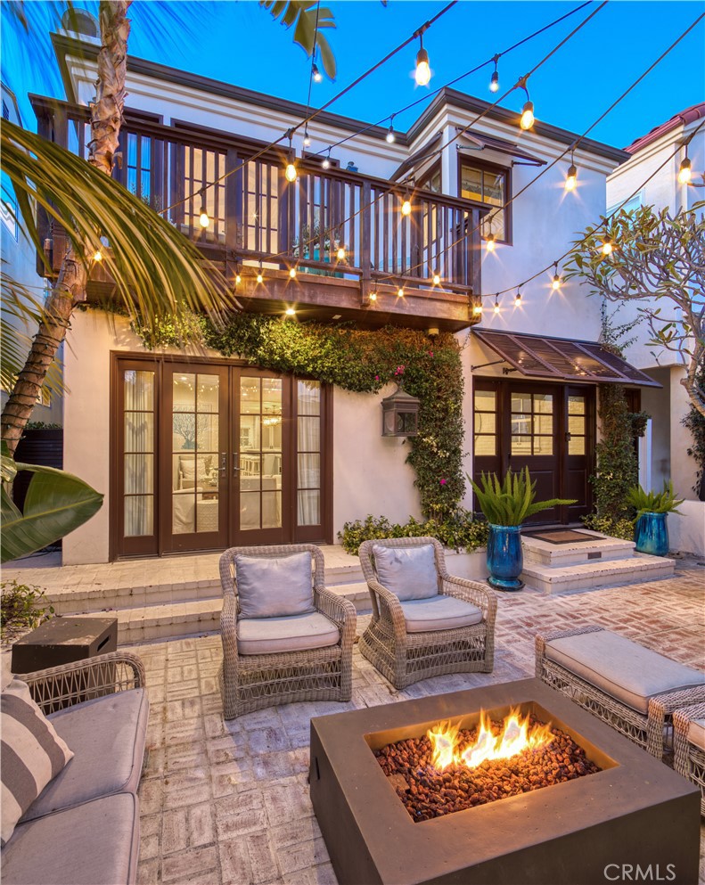 a view of a house with swimming pool and furniture