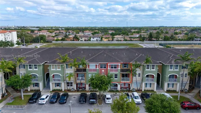 a front view of a house with a garden and plants