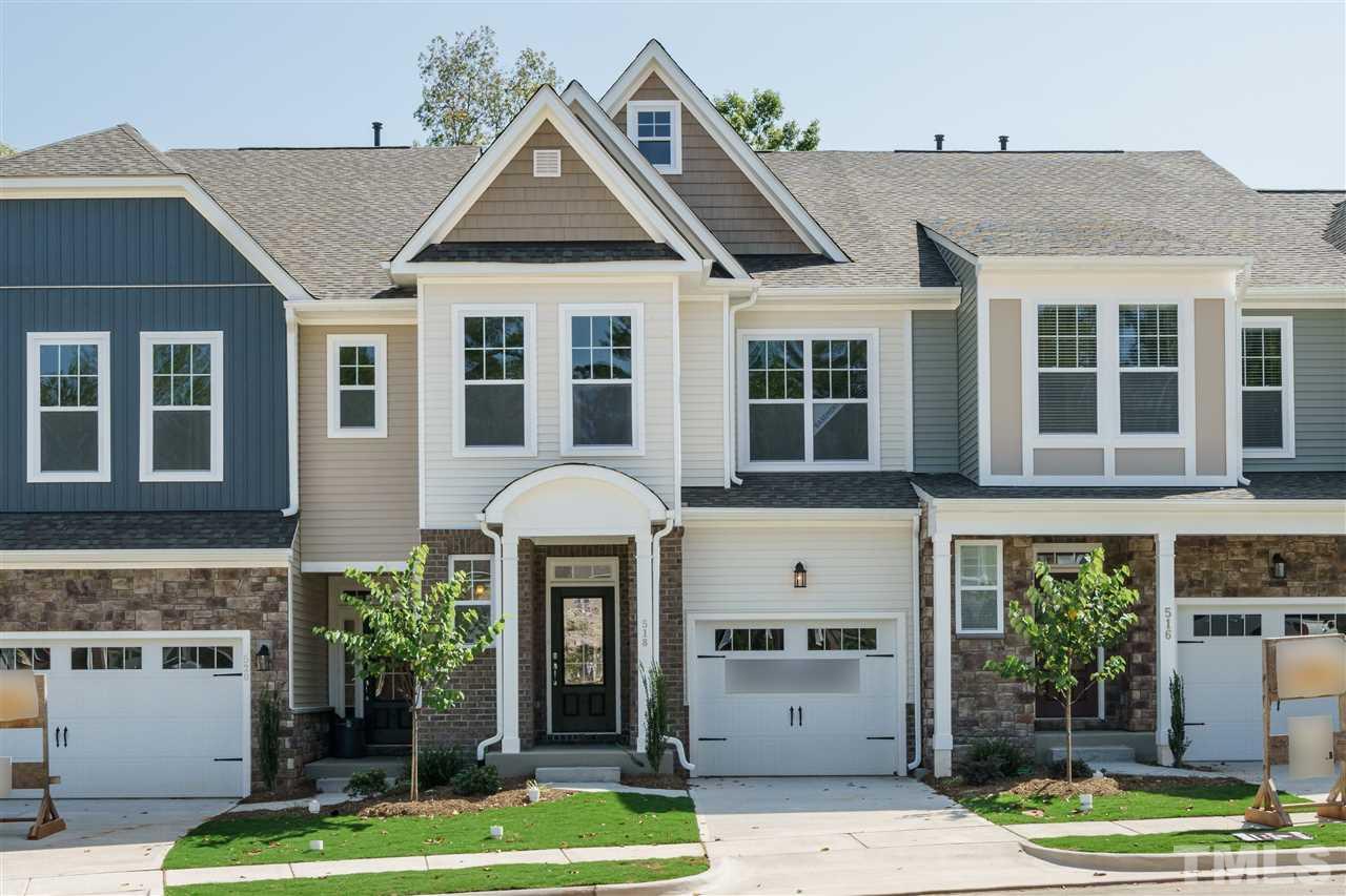 318 Roberts Ridge Drive Cary, NC 27513 - Photo 1 of 18 a front view of a house with a yard and potted plants