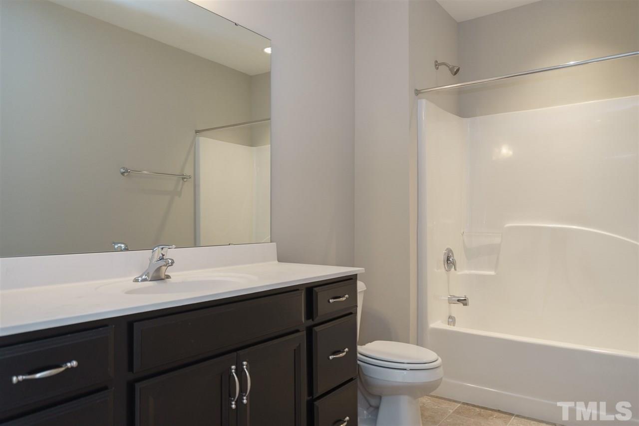 318 Roberts Ridge Drive Cary, NC 27513 - Photo 14 of 18 a bathroom with a sink toilet and a mirror