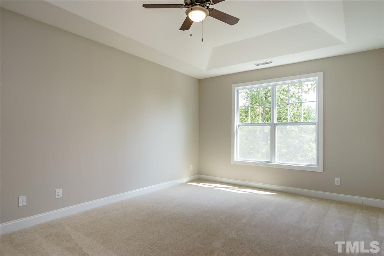 318 Roberts Ridge Drive Cary, NC 27513 - Photo 6 of 18 an empty room with a window and a fan
