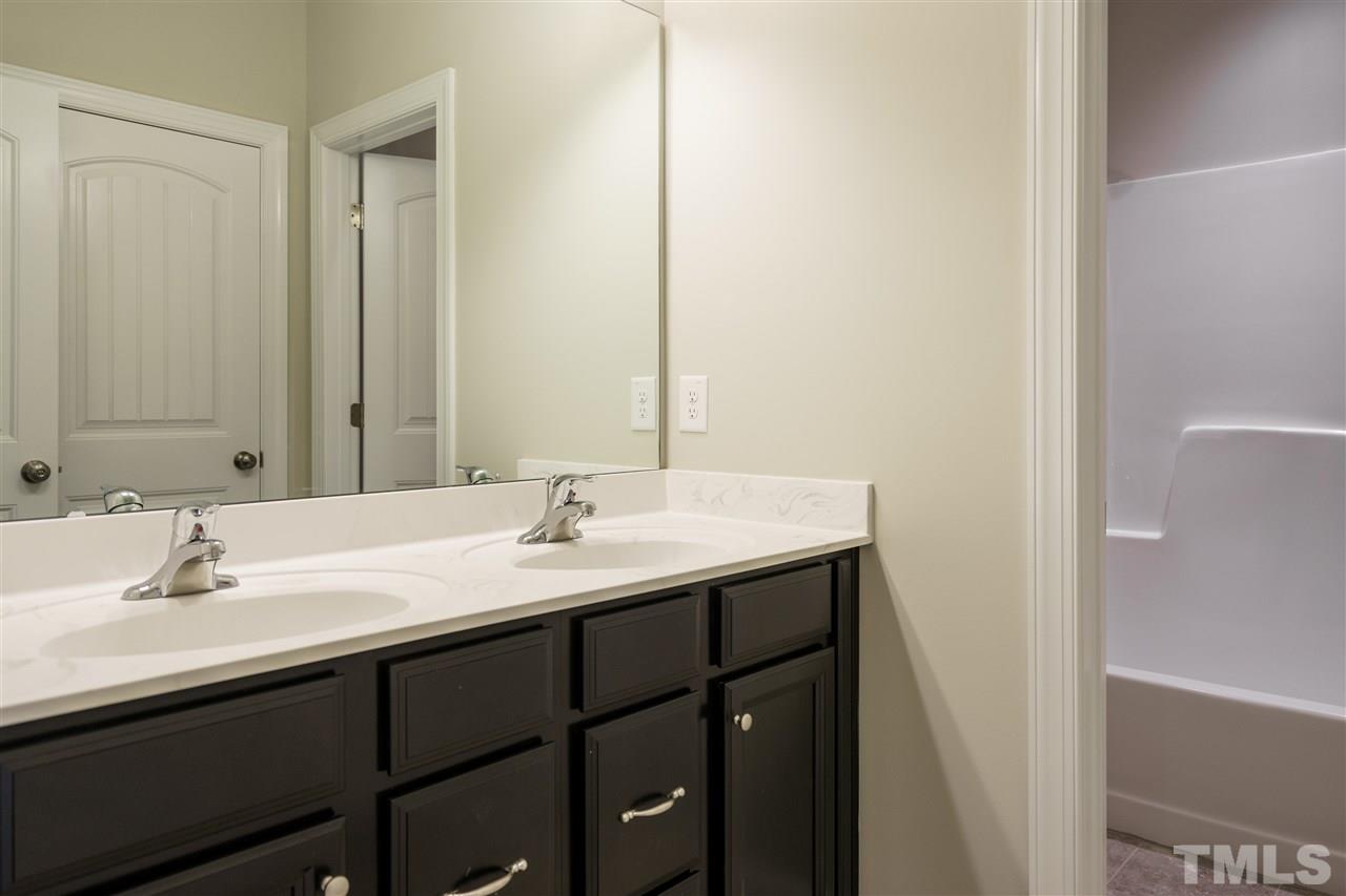 318 Roberts Ridge Drive Cary, NC 27513 - Photo 9 of 18 a bathroom with a sink and a mirror