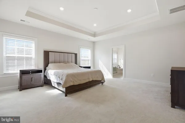 a spacious bedroom with a bed and window