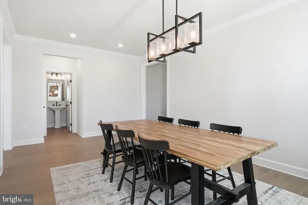 a kitchen with stainless steel appliances granite countertop a sink a stove a refrigerator and chairs