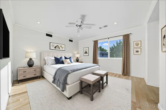 a spacious bedroom with a bed and a chandelier