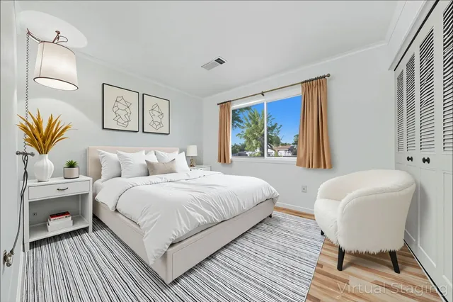 a bedroom with a bed and a painting on the wall