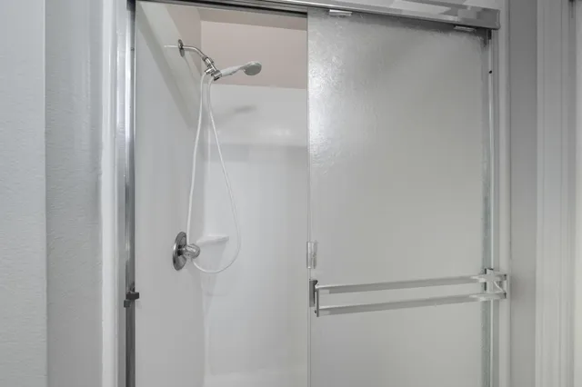 a bathroom with a glass shower door