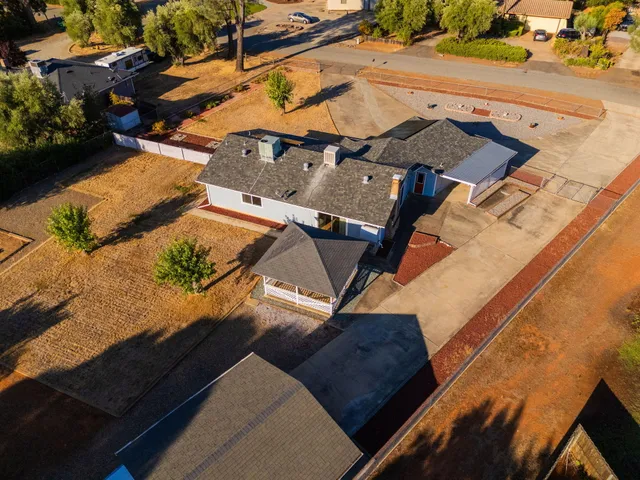 an aerial view of a house with a yard