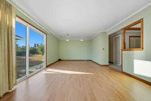 a view of room with window and wooden floor