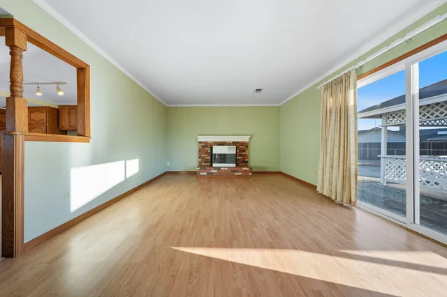 a view of a room with wooden floor