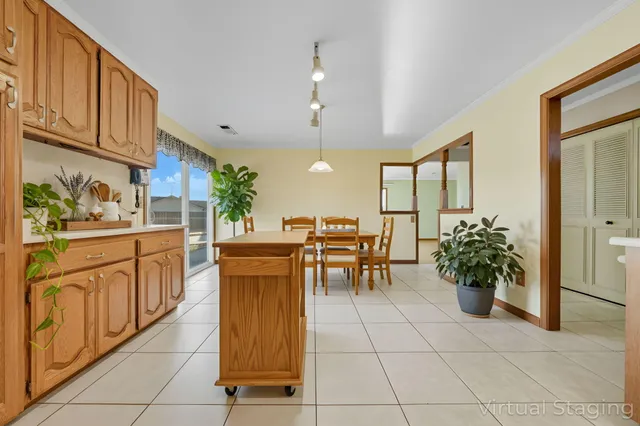 a kitchen with stainless steel appliances kitchen island granite countertop a refrigerator a sink dishwasher and white cabinets with wooden floor