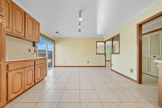 a large kitchen with stainless steel appliances granite countertop a stove a sink and a cabinets