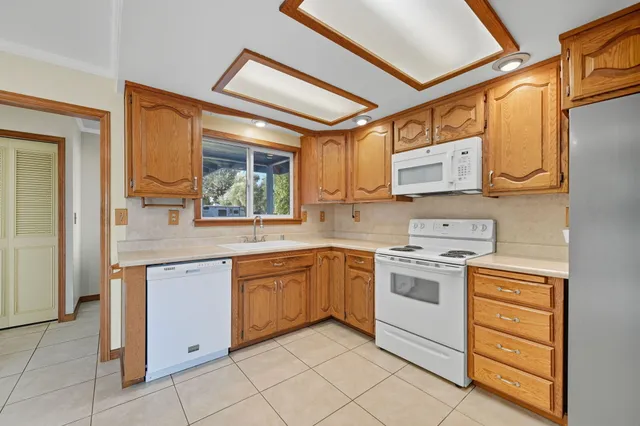 a kitchen with stainless steel appliances granite countertop a sink and cabinets