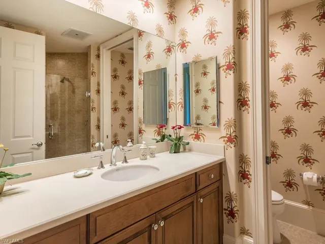 a bedroom with a bed dresser and a large window