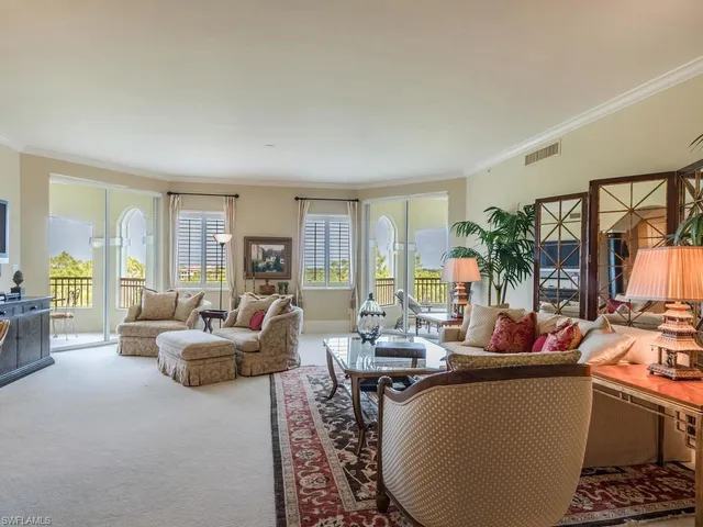 a living room with fireplace furniture and a floor to ceiling window