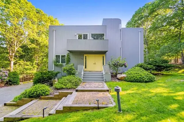 a front view of a house with garden