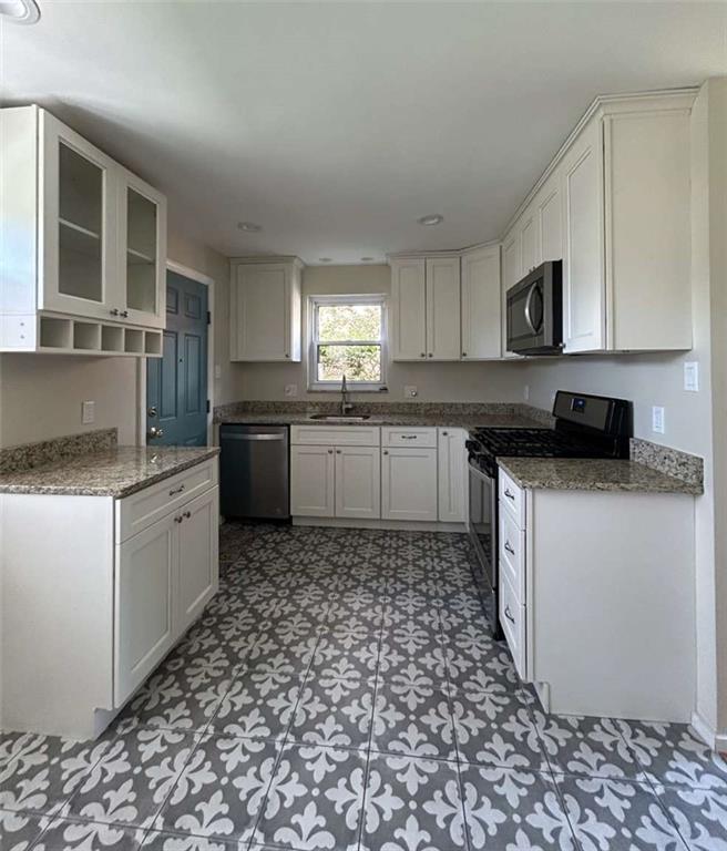344 Spring Valley Road Pittsburgh, PA 15243 - Photo 3 of 10 a kitchen with a sink a stove and cabinets