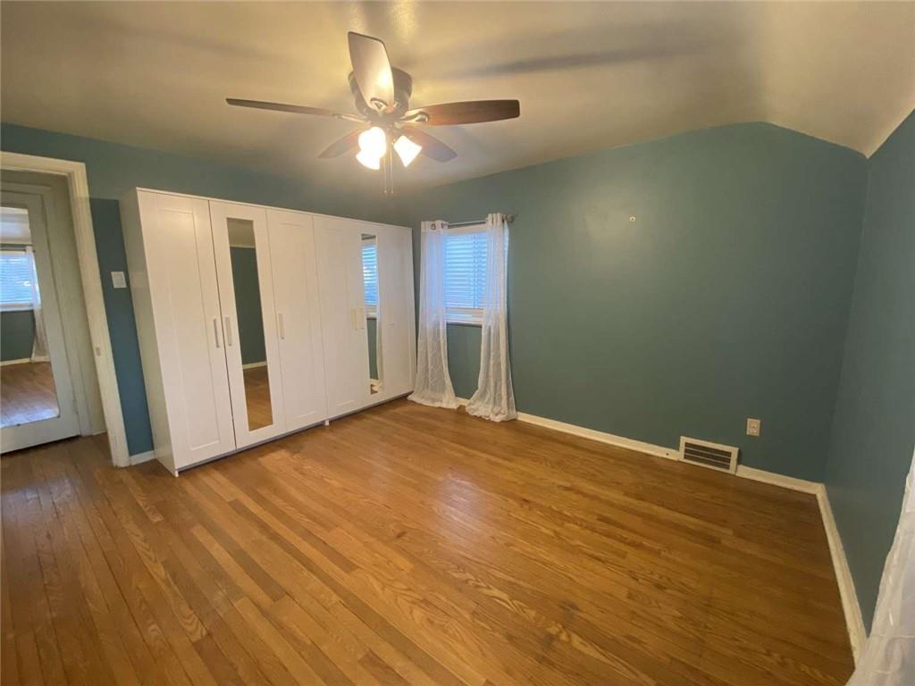 344 Spring Valley Road Pittsburgh, PA 15243 - Photo 7 of 10 an empty room with wooden floor and way to kitchen