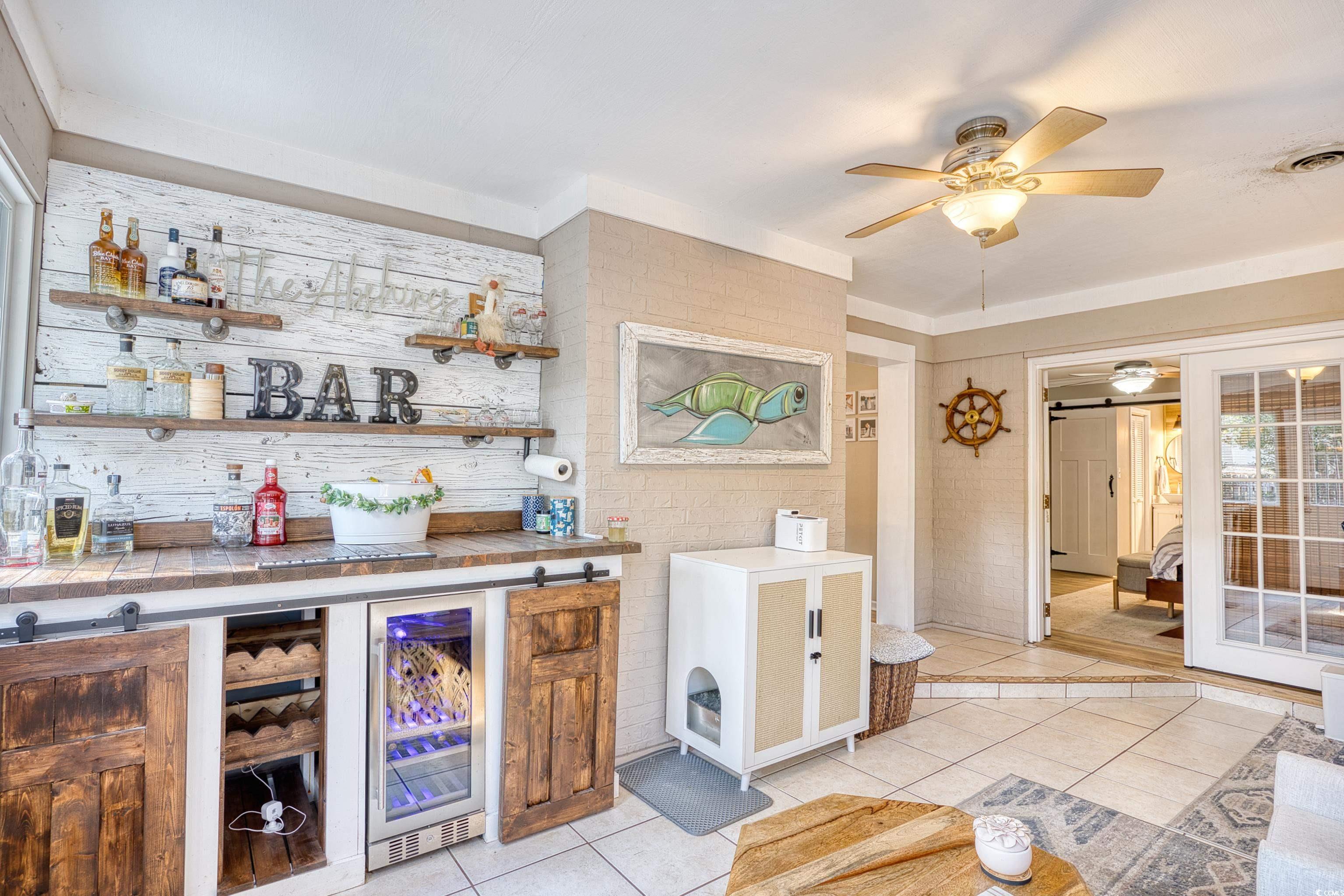 752 Kittiwake Lane Murrells Inlet, SC 29576 - Photo 15 of 35 Bar featuring a barn door and a wine cooler