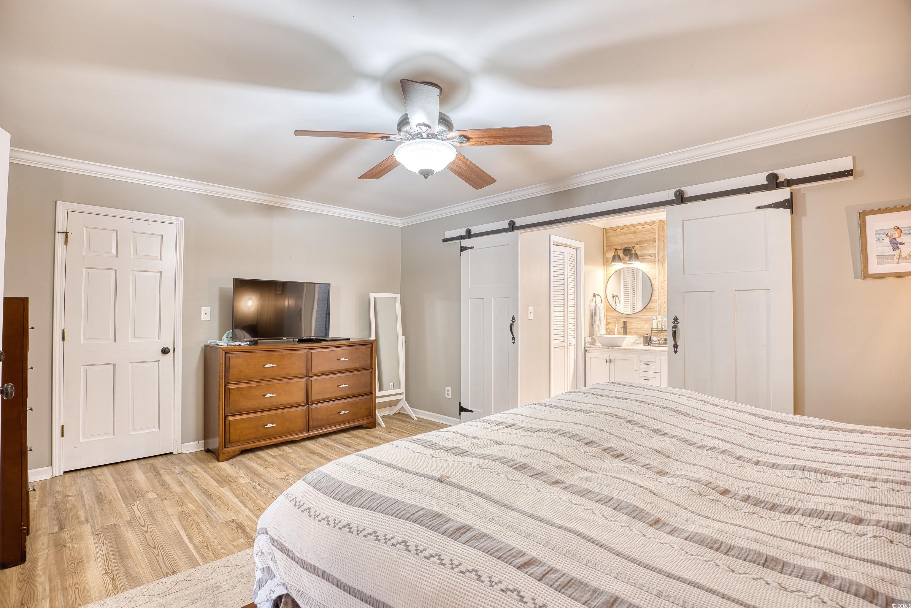 752 Kittiwake Lane Murrells Inlet, SC 29576 - Photo 18 of 35 Bedroom featuring ceiling fan, a barn door, ensuit