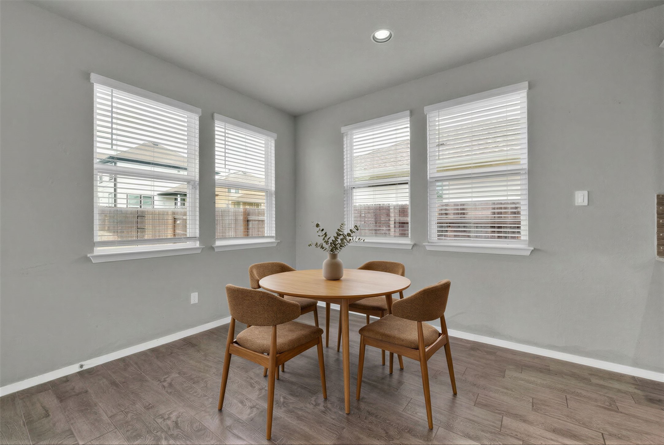 101 Crescent Street Georgetown, TX 78626 - Photo 13 of 39 Virtually staged - Dining area features rich wood flooring and well-lit windows, perfect for everyday meals.