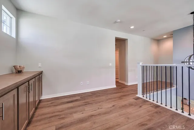 a view of a hallway with wooden floor and entryway