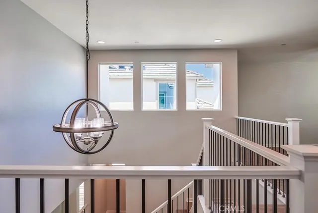 a view of staircase with open kitchen view