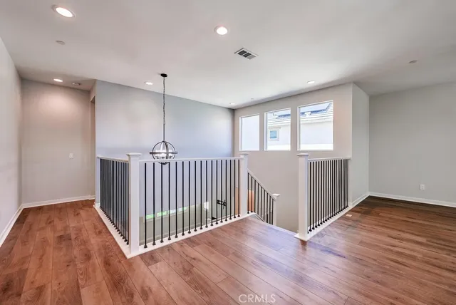 a view of a room with wooden floor windows and stairs