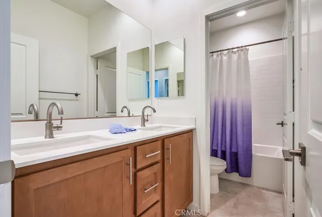 a bathroom with a double vanity sink and mirror