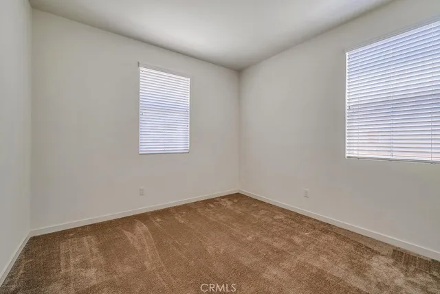 a view of empty room with ceiling fan
