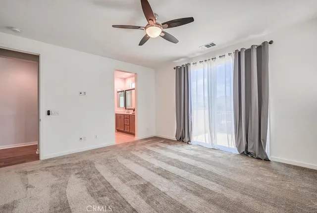 a view of a livingroom with a ceiling fan and window