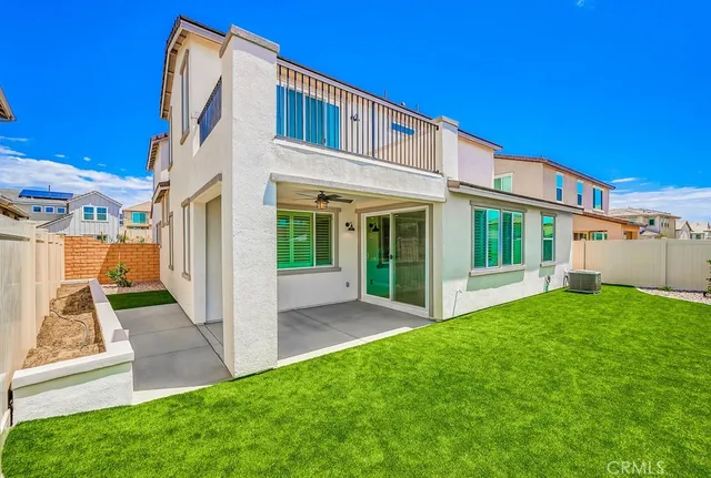 a view of a chair and table in backyard of the house