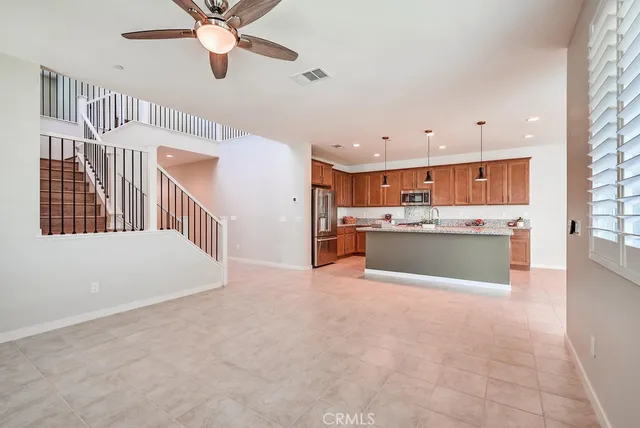 a view of kitchen with cabinets and window