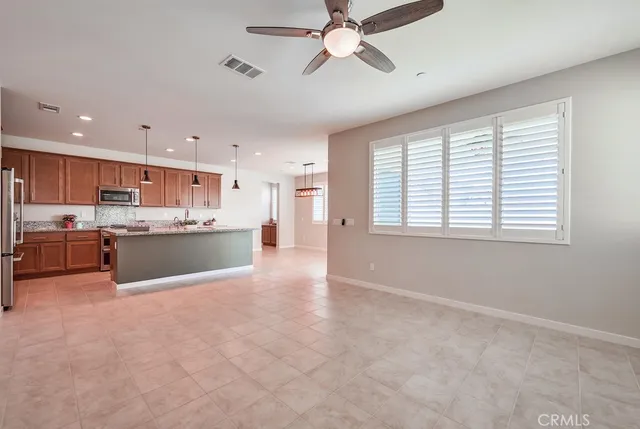 a view of kitchen with kitchen island a sink wooden floor and a window