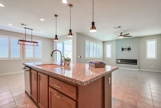 a kitchen with granite countertop a sink and stove