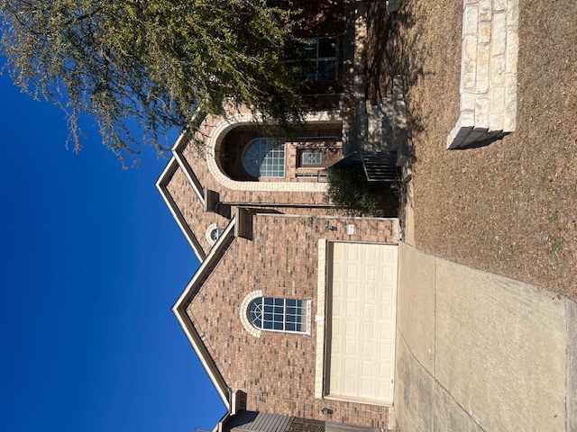 1374 Red Stag Place Round Rock, TX 78665 - Photo 2 of 34 View of front facade with a garage, brick siding, and driveway