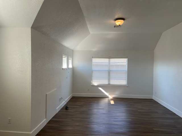 1374 Red Stag Place Round Rock, TX 78665 - Photo 21 of 34 Spare room featuring dark wood finished floors and a textured wall