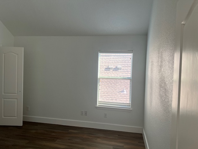 1374 Red Stag Place Round Rock, TX 78665 - Photo 24 of 34 Spare room with baseboards and dark wood-type flooring