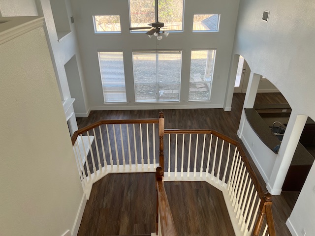 1374 Red Stag Place Round Rock, TX 78665 - Photo 28 of 34 Staircase featuring wood finished floors, a high ceiling, a ceiling fan, and arched walkways