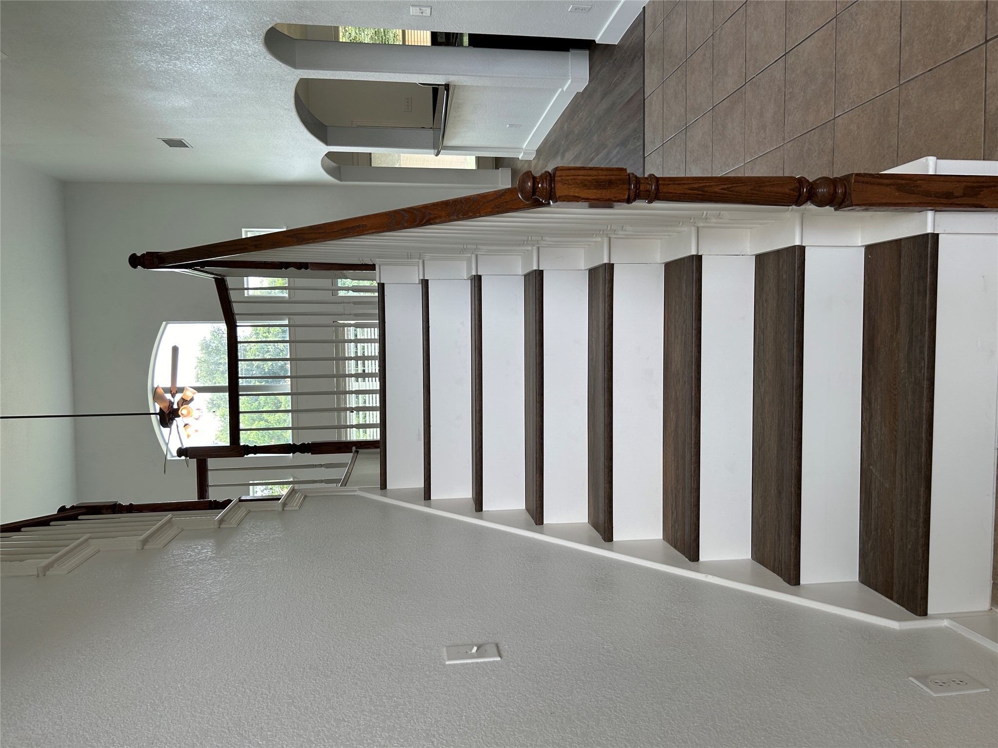 1374 Red Stag Place Round Rock, TX 78665 - Photo 29 of 34 Stairs featuring arched walkways, a textured wall, and a ceiling fan