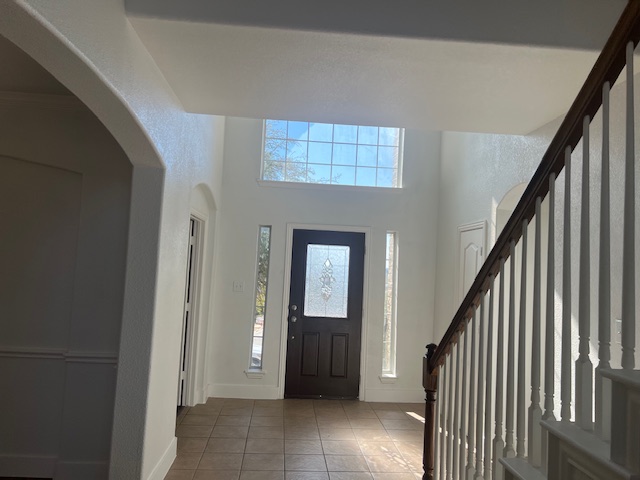1374 Red Stag Place Round Rock, TX 78665 - Photo 3 of 34 Tiled entryway featuring a high ceiling, healthy amount of natural light, and arched walkways
