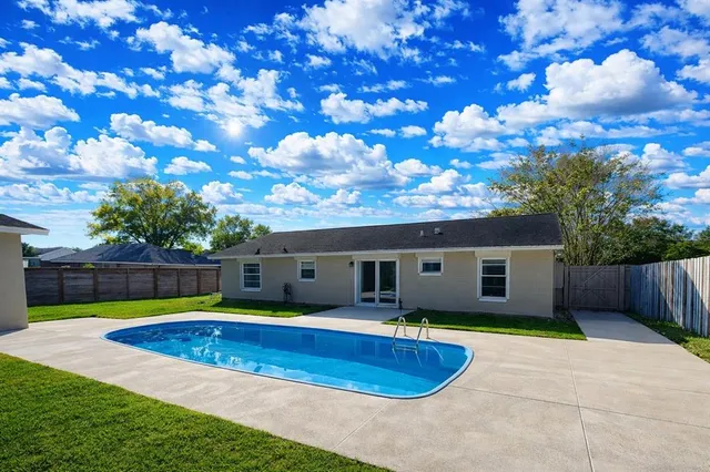 a house with swimming pool in front of it