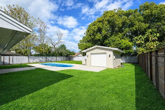 a view of a house with backyard and a garden
